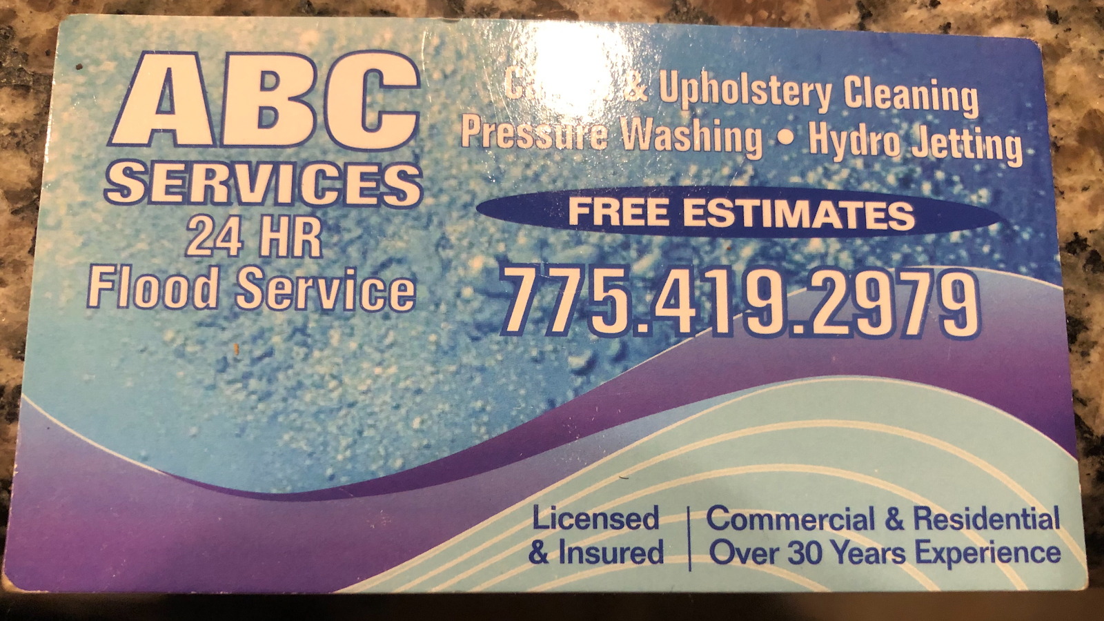 ABC Services card listing carpet and upholstery cleaning, pressure washing, hydro jetting and 24-hour flood service